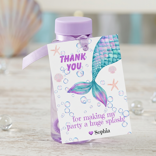 A personalized mermaid-themed thank you bottle with a lavender cap and ribbon, featuring a printed tag with a colorful mermaid tail, bubbles, starfish, and the text 'THANK YOU for making my party a huge splash! Sophia'.
