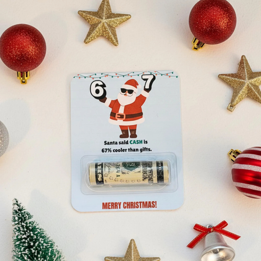 A Christmas-themed cash roll gift card featuring a Santa Claus illustration and the text 'Santa said CASH is 67% cooler than gifts' and 'MERRY CHRISTMAS!'. A rolled dollar bill is sealed in a clear plastic window at the bottom.