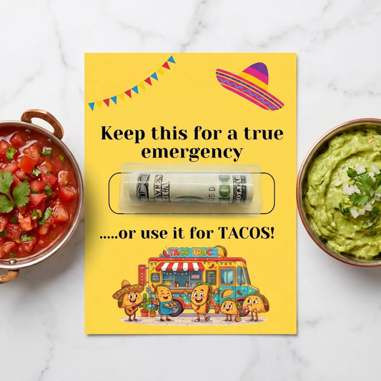 A yellow emergency cash card with a clear window showing a rolled dollar bill, surrounded by bowls of salsa, guacamole, and tacos on a white marble surface. The card features festive Mexican-themed illustrations including a sombrero, bunting, a food truck, and cartoon tacos.