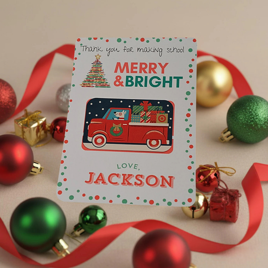 A personalized Christmas thank-you card for school, featuring a red cartoon truck carrying presents, surrounded by red and green ornaments and a red ribbon on a light beige background.