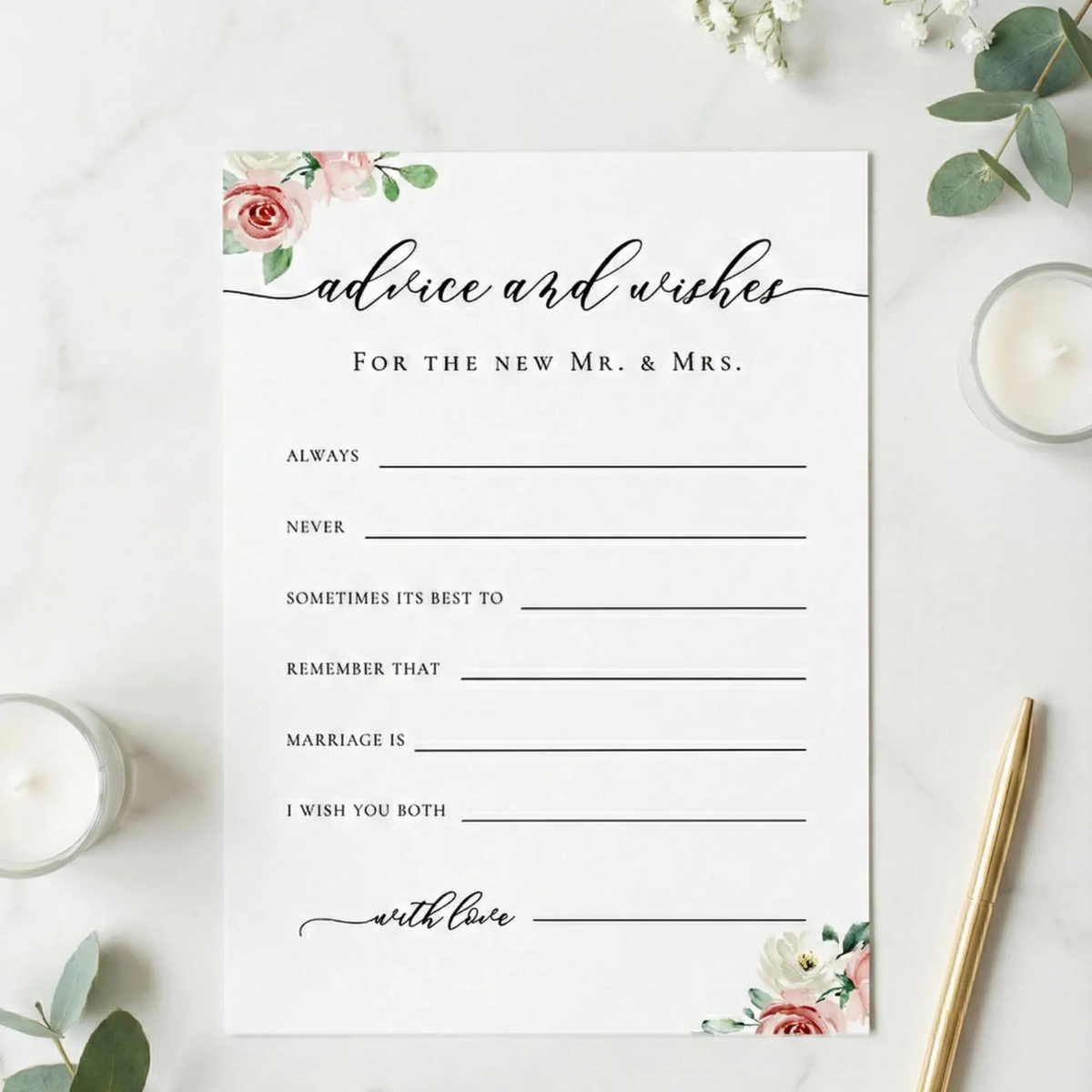 A square white wedding advice and wishes card with elegant black script and floral watercolor accents in pink, red, and green, styled on a white marble surface with candles, greenery, and a gold pen.