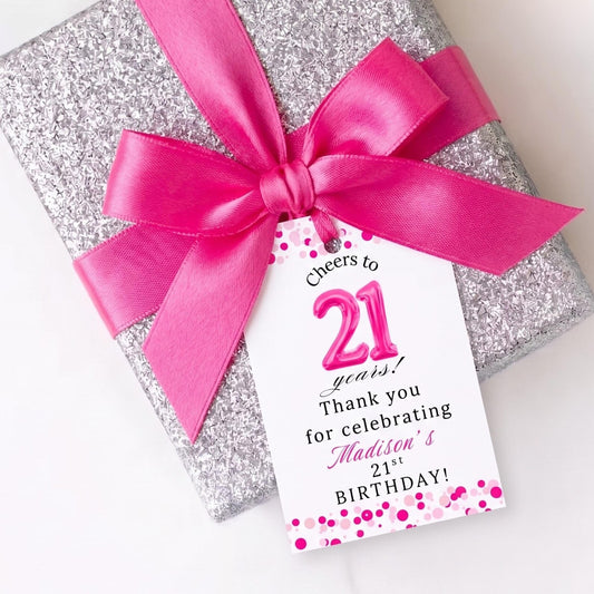 Cheers to 21 years! Thank you for celebrating Madison's 21st Birthday! Gift tags attached to a sparkly silver gift box with bright pink ribbon bow.